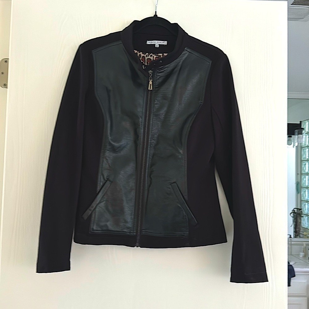 This is pleather but looks like leather. A bit stretchy. Lightly worn.